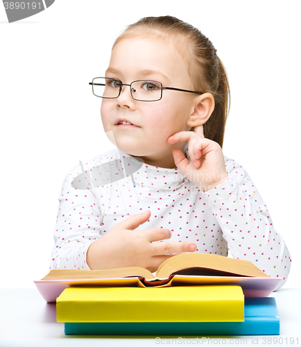 Image of Little girl is reading a book