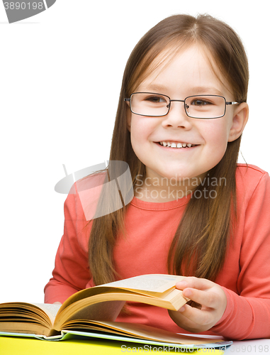 Image of Little girl is reading a book