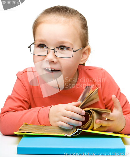 Image of Little girl is reading a book