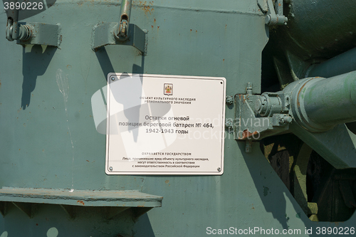 Image of Vityazevo, Russia - April 8, 2016: A sign with the inscription \"Remains of the firing position coastal battery 464, 1942-1943 years\" on the coastal gun - a monument in the village of Vityazevo, a su