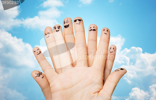 Image of close up of hands and fingers with smiley faces