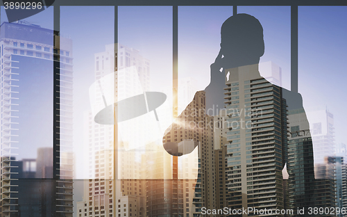 Image of silhouette of business man calling on smartphone