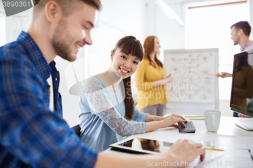 Image of creative team with tablet pc computer at office