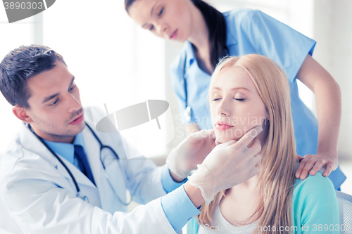 Image of male plastic surgeon with patient