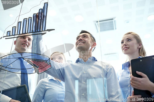 Image of smiling business people with marker and stickers