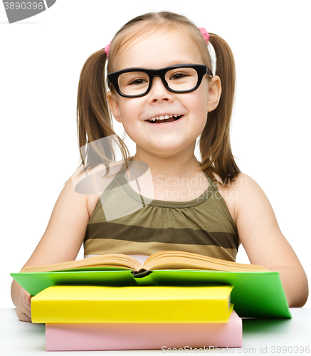 Image of Little girl is reading a book