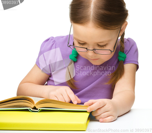 Image of Little girl is reading a book