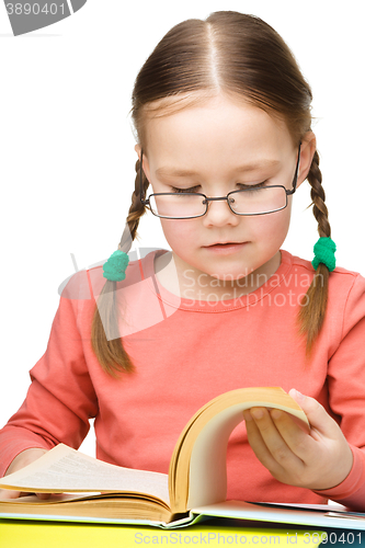 Image of Little girl is reading a book