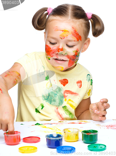 Image of Portrait of a cute girl playing with paints