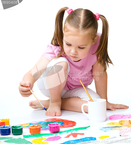 Image of Cute cheerful child play with paints