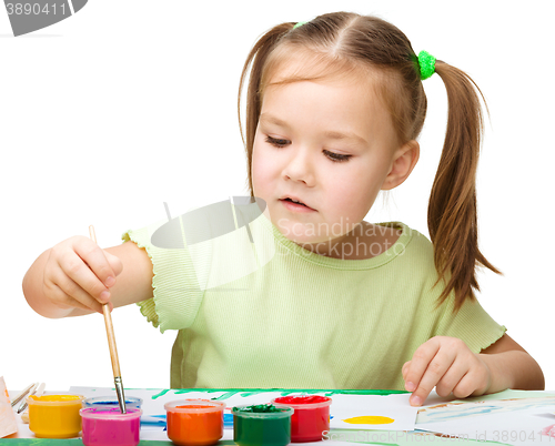 Image of Cute cheerful child play with paints