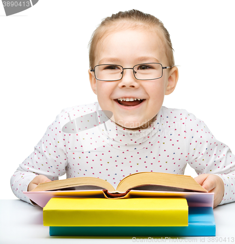 Image of Little girl is reading a book