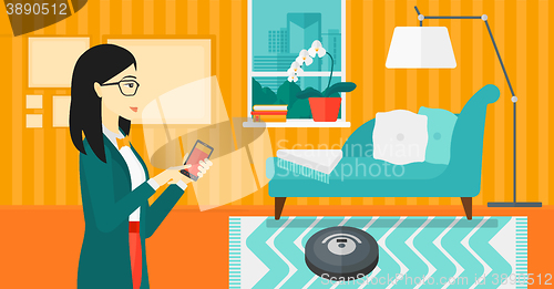 Image of Woman with robot vacuum cleaner.