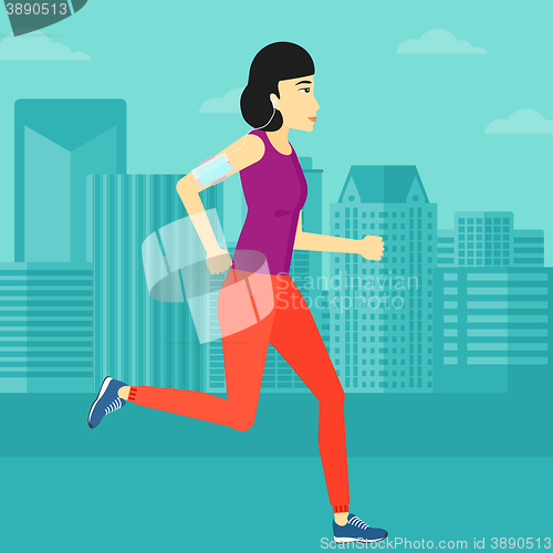 Image of Woman jogging with earphones and smartphone.