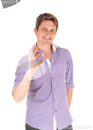 Image of Smiling man giving OK with fingers.