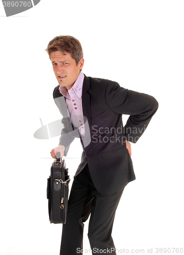 Image of Businessman walking with back pain.