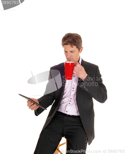 Image of Businessman drinking coffee.