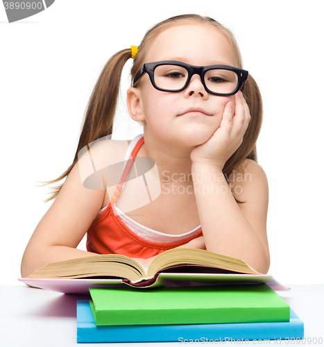 Image of Little girl is reading a book