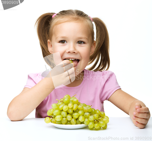 Image of Little girl is eating grapes