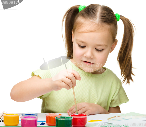 Image of Cute cheerful child play with paints