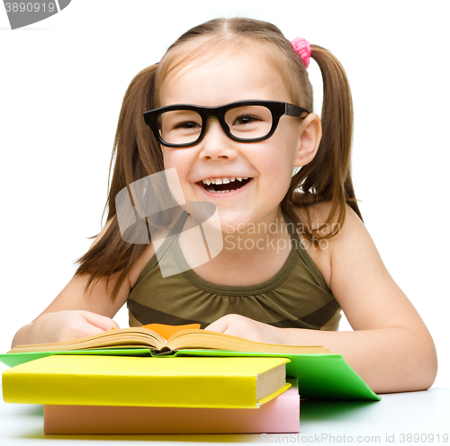 Image of Little girl is reading a book