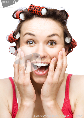 Image of Woman is holding her face in astonishment