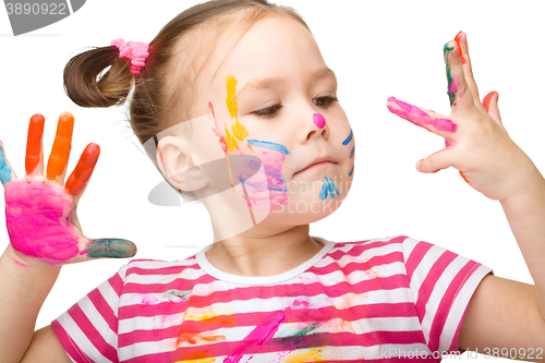 Image of Portrait of a cute girl playing with paints