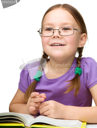 Image of Little girl is reading a book