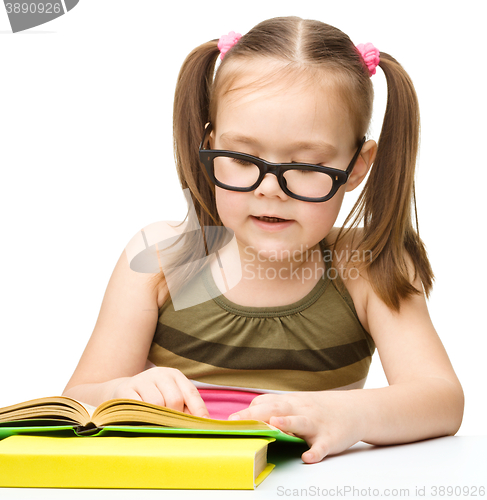 Image of Little girl is reading a book