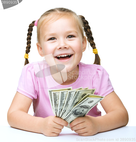 Image of Little girl with dollars