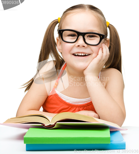 Image of Little girl is reading a book