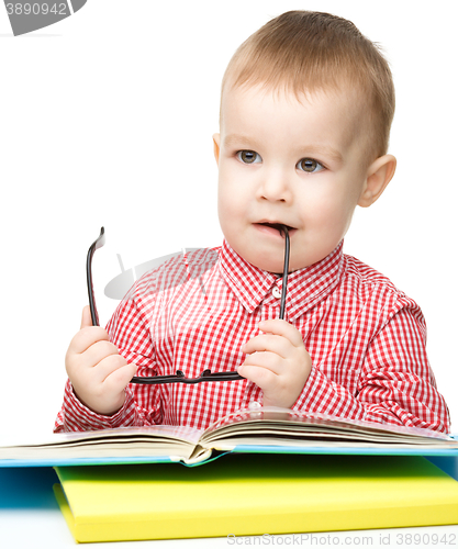 Image of Little child play with book