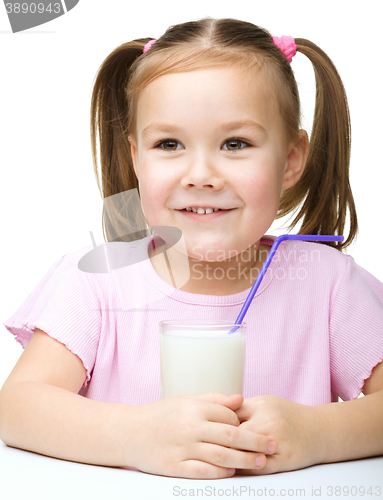 Image of Cute little girl with a glass of milk