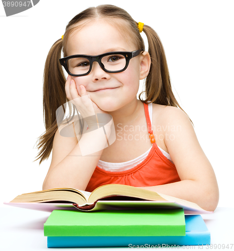 Image of Little girl is reading a book