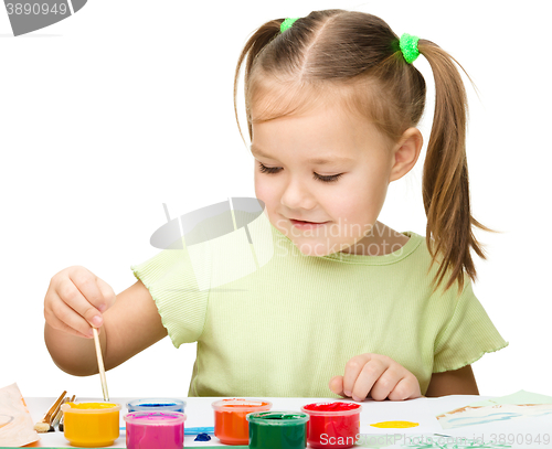 Image of Cute cheerful child play with paints