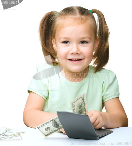 Image of Little girl is counting dollars