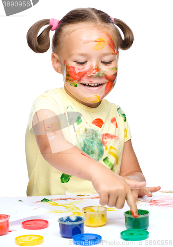 Image of Portrait of a cute girl playing with paints