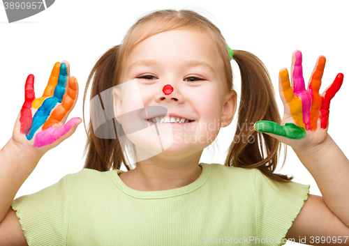 Image of Portrait of a cute girl playing with paints
