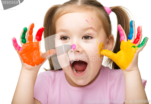 Image of Portrait of a cute girl playing with paints