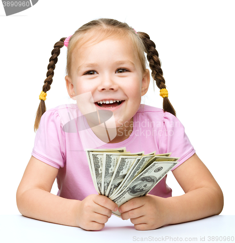 Image of Little girl with dollars