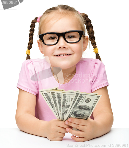 Image of Little girl is counting dollars