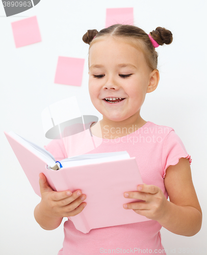 Image of Little girl is reading a book