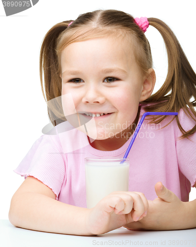 Image of Cute little girl with a glass of milk