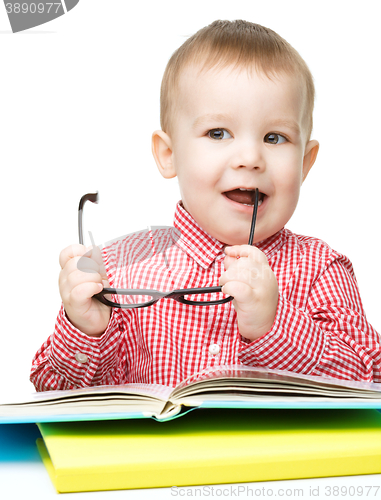 Image of Little child play with book