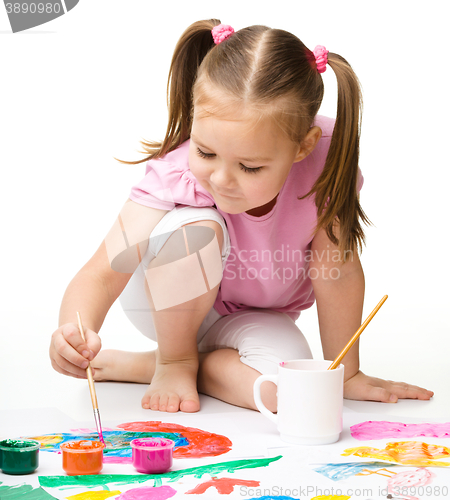 Image of Cute cheerful child play with paints