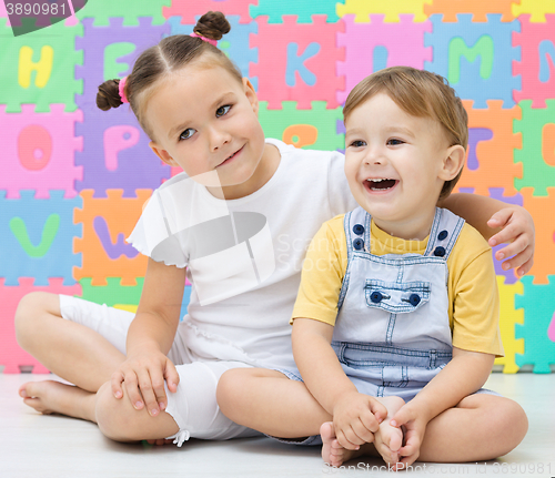 Image of Children are sitting on floor