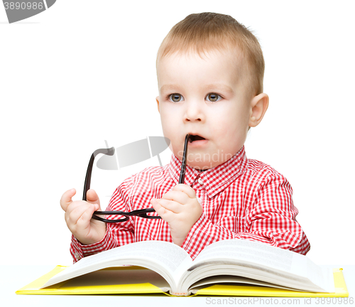 Image of Little child play with book