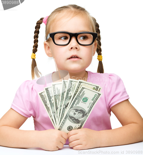 Image of Little girl is counting dollars