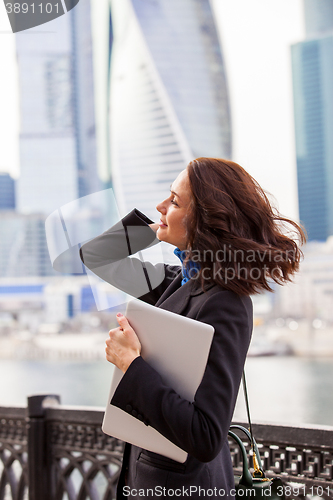 Image of smiling woman with a laptop