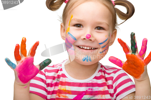 Image of Portrait of a cute girl playing with paints